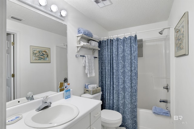 full bathroom with toilet, vanity, a textured ceiling, and shower / bath combo with shower curtain