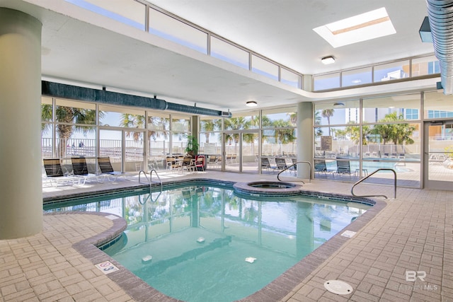 view of swimming pool featuring a skylight