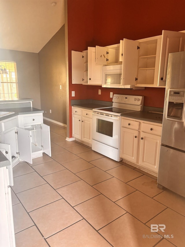 kitchen with light tile patterned floors, open shelves, dark countertops, white appliances, and lofted ceiling
