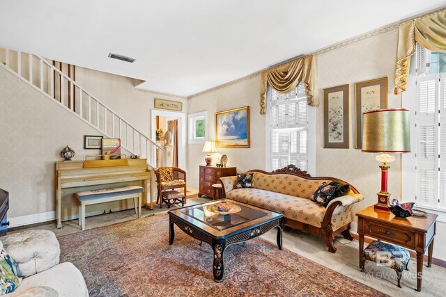 living room with carpet flooring and ornamental molding