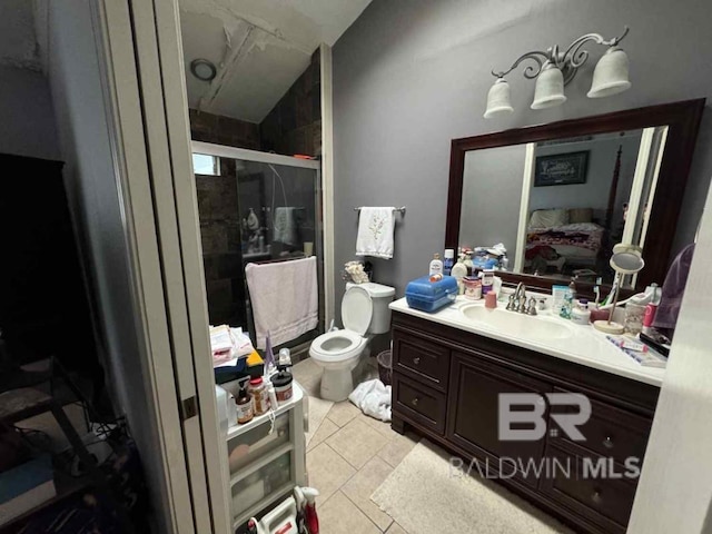 bathroom with tile patterned floors, vanity, and a shower with door