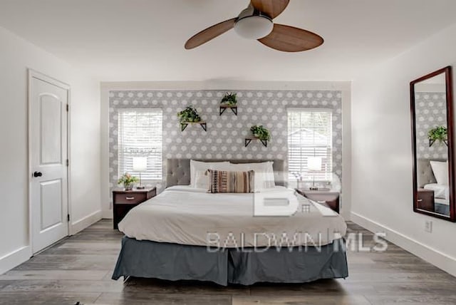 bedroom with multiple windows, hardwood / wood-style flooring, and ceiling fan