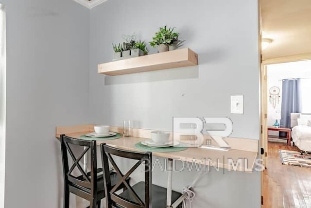 dining space with wood-type flooring