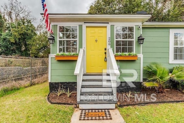 property entrance with a yard