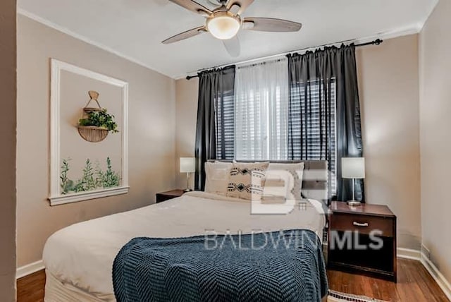 bedroom with dark wood-type flooring and ceiling fan