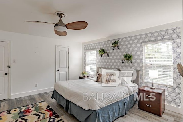 bedroom with hardwood / wood-style floors and ceiling fan