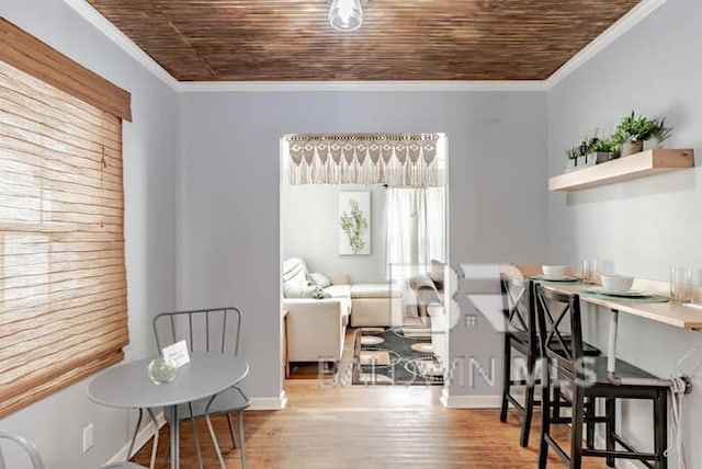 dining room with crown molding, wood ceiling, and light hardwood / wood-style floors