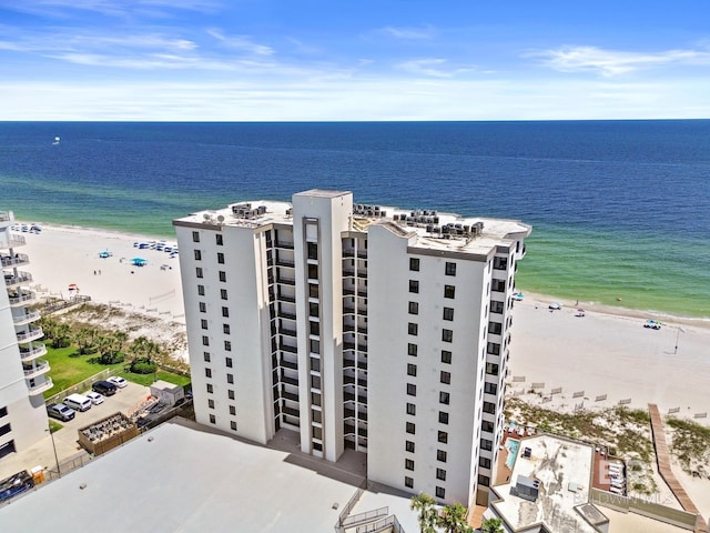 aerial view with a water view and a beach view