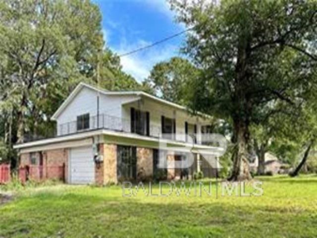 back of property featuring a lawn