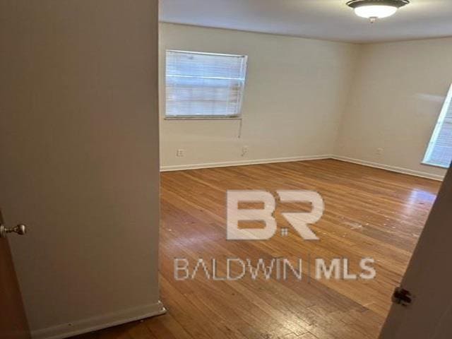 spare room with wood-type flooring