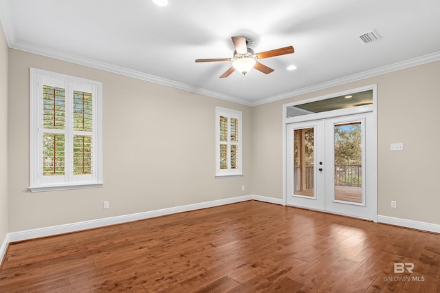 unfurnished room with wood finished floors, crown molding, french doors, and visible vents