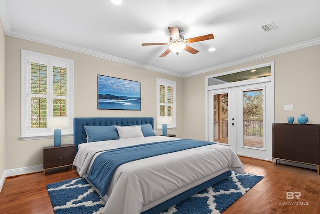 bedroom with wood finished floors, visible vents, french doors, access to outside, and multiple windows