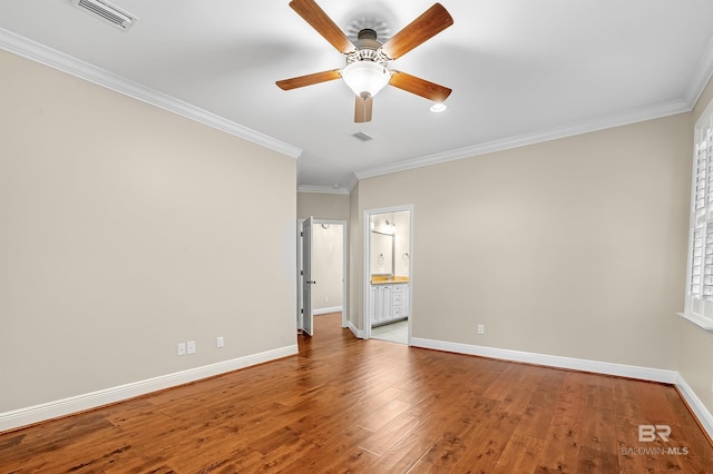 unfurnished bedroom featuring visible vents, ornamental molding, baseboards, and wood finished floors