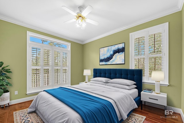 bedroom featuring baseboards, wood finished floors, and ornamental molding