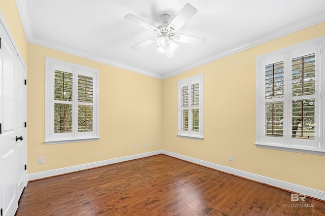 empty room with ceiling fan, baseboards, dark wood finished floors, and crown molding