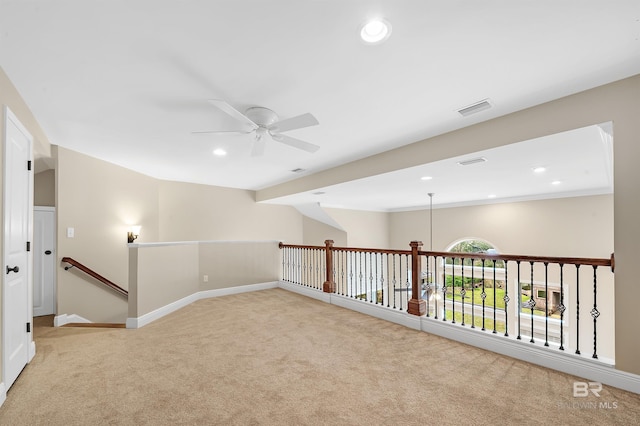 unfurnished room with visible vents, baseboards, light colored carpet, recessed lighting, and a ceiling fan