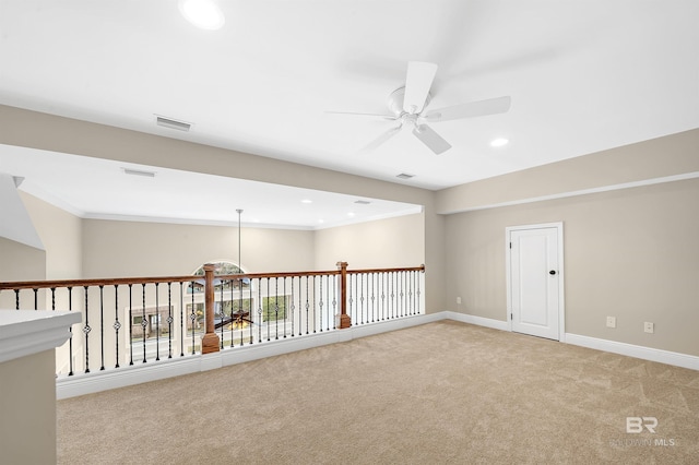 spare room with visible vents, light carpet, recessed lighting, baseboards, and ceiling fan