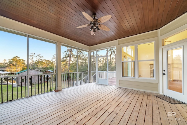 unfurnished sunroom with wooden ceiling and ceiling fan