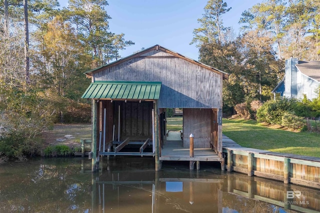 view of dock featuring a yard and a water view