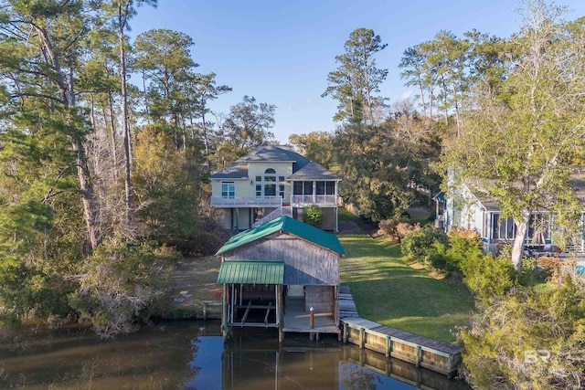 dock area featuring a lawn and a water view