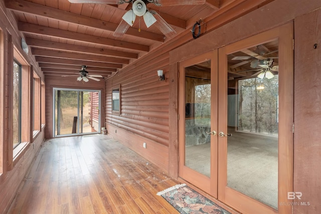 unfurnished sunroom with wood ceiling, ceiling fan, beam ceiling, and french doors