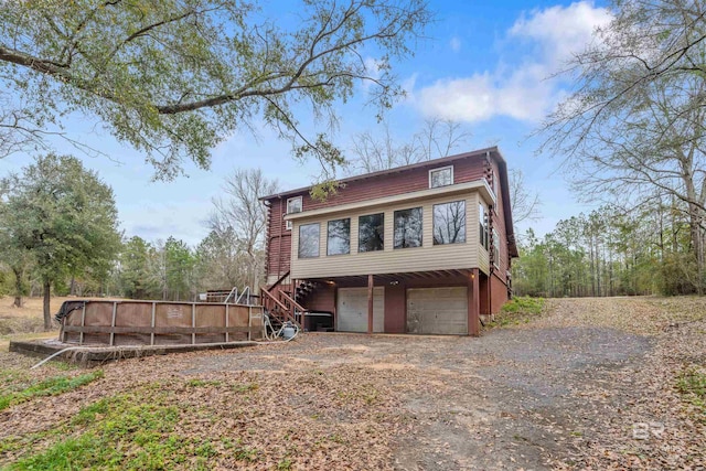 exterior space with a pool and a garage