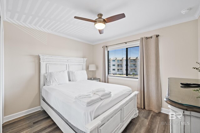 bedroom with ceiling fan, ornamental molding, and dark hardwood / wood-style flooring