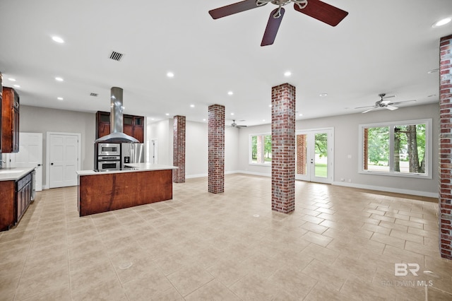 15031 Timber Ridge Dr, Loxley, AL 36551 - kitchen with appliances with stainless steel finishes, decorative columns, exhaust hood, and a ceiling fan