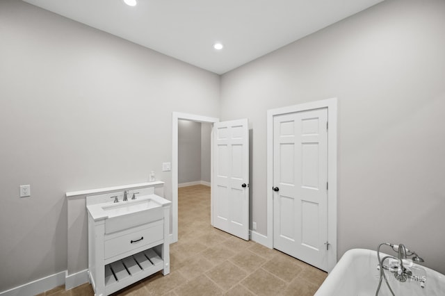 15031 Timber Ridge Dr, Loxley, AL 36551 - full bathroom with a soaking tub, vanity, baseboards, and recessed lighting