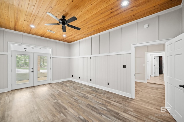 15031 Timber Ridge Dr, Loxley, AL 36551 - unfurnished room with a decorative wall, ceiling fan, wood ceiling, wood finished floors, and french doors