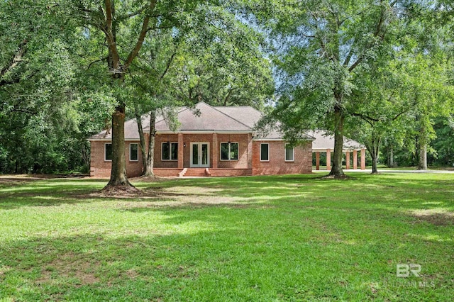 15031 Timber Ridge Dr, Loxley, AL 36551 - view of front of house featuring french doors, brick siding, a front yard, and a chimney