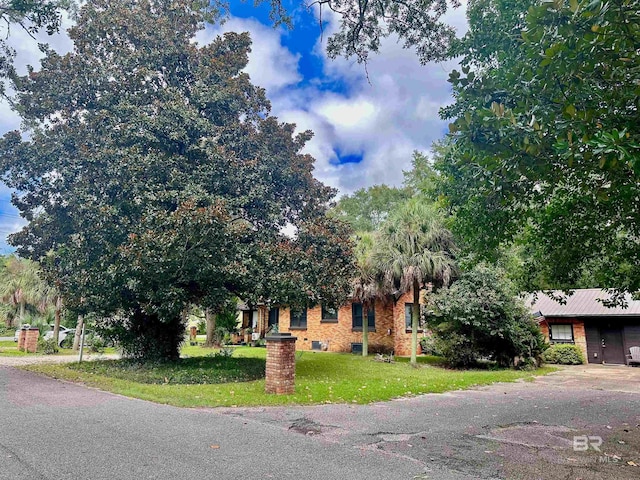531 W Laurel Ave, Foley, AL 36535 - view of property hidden behind natural elements featuring a front yard