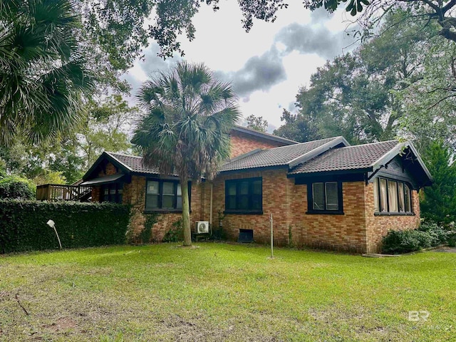 531 W Laurel Ave, Foley, AL 36535 - back of house with a lawn, a tile roof, and brick siding
