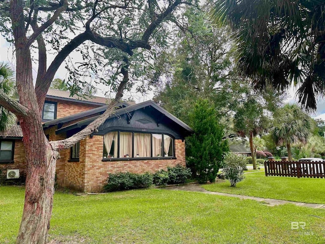 531 W Laurel Ave, Foley, AL 36535 - view of property exterior with brick siding and a lawn