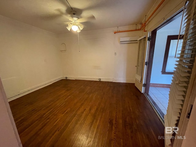 531 W Laurel Ave, Foley, AL 36535 - unfurnished room featuring dark wood finished floors, ceiling fan, a wall mounted AC, and baseboards