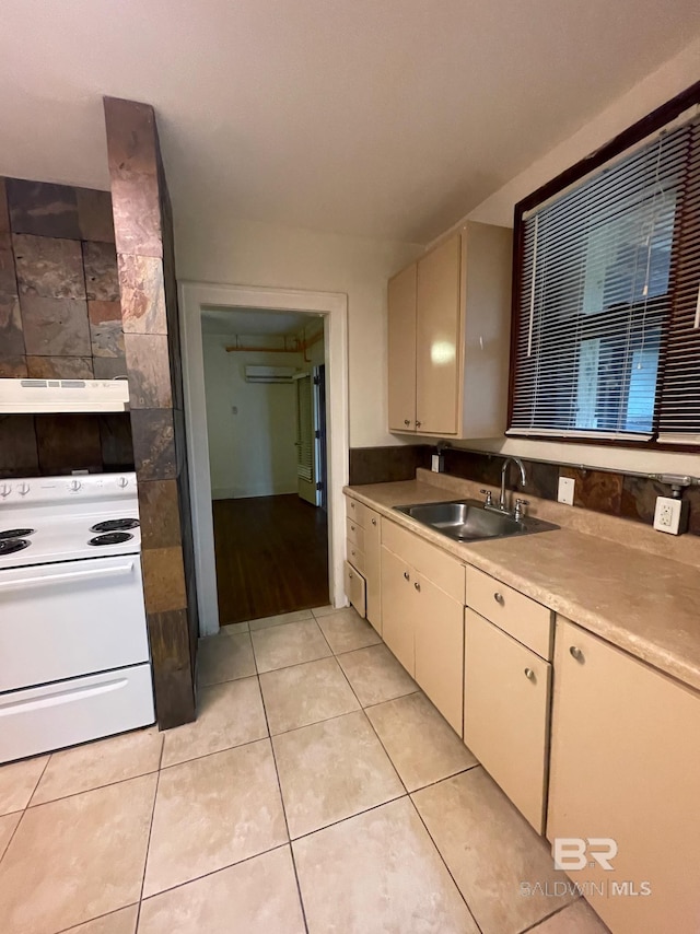 531 W Laurel Ave, Foley, AL 36535 - kitchen featuring white electric stove, a sink, under cabinet range hood, light tile patterned flooring, and light countertops