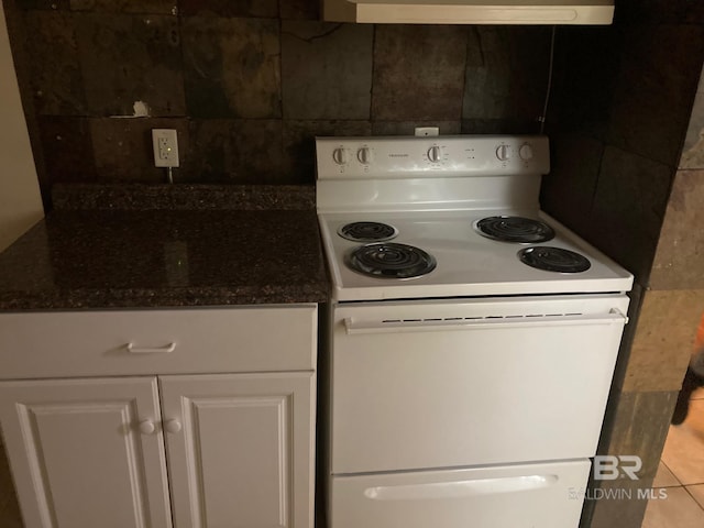 531 W Laurel Ave, Foley, AL 36535 - kitchen featuring electric range, white cabinetry, backsplash, and dark stone countertops
