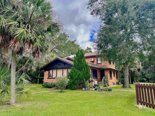 531 W Laurel Ave, Foley, AL 36535 - view of front of home with a front lawn, a chimney, and brick siding