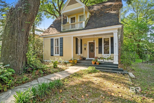 view of front facade featuring a balcony and covered porch