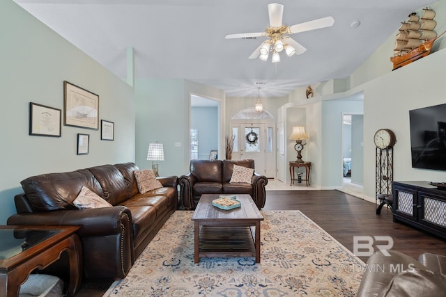 living room with a ceiling fan, wood finished floors, and baseboards