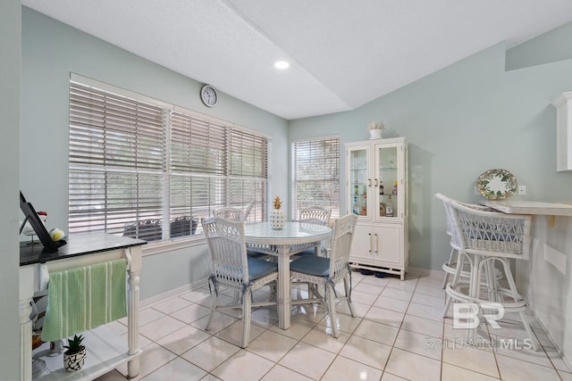 dining area featuring baseboards and light tile patterned flooring