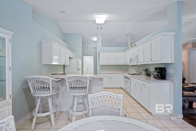 kitchen featuring white cabinetry, white appliances, a peninsula, and light countertops