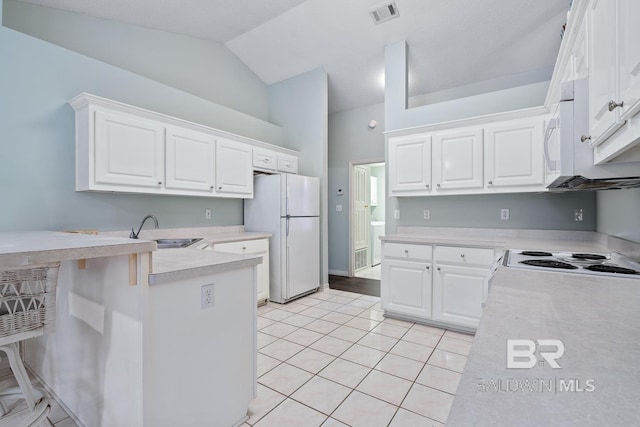 kitchen featuring white appliances, visible vents, a sink, light countertops, and white cabinetry