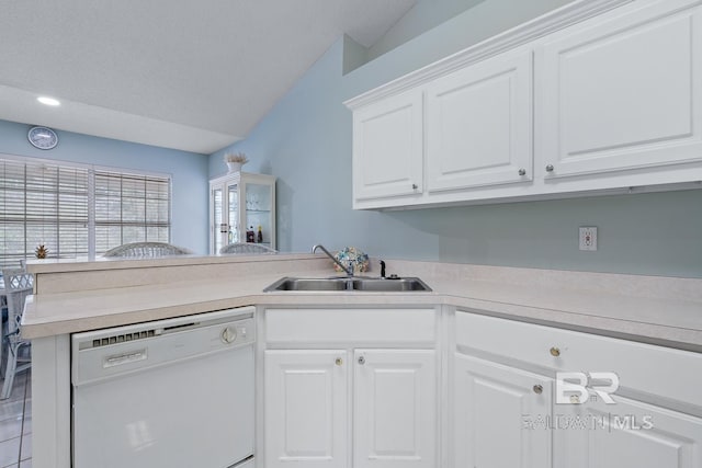 kitchen with a sink, a peninsula, white cabinets, light countertops, and dishwasher