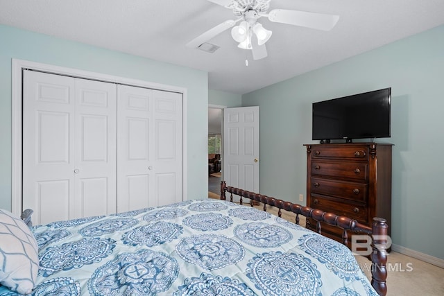 carpeted bedroom with a closet, visible vents, ceiling fan, and baseboards