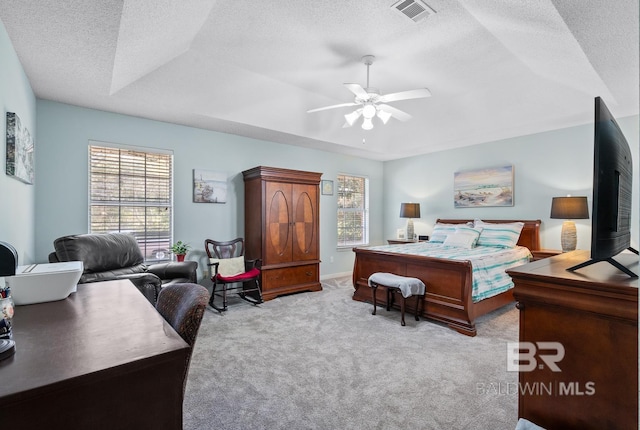 bedroom with visible vents, carpet flooring, a textured ceiling, and ceiling fan