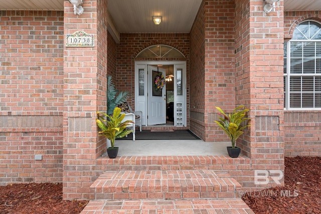 property entrance with brick siding