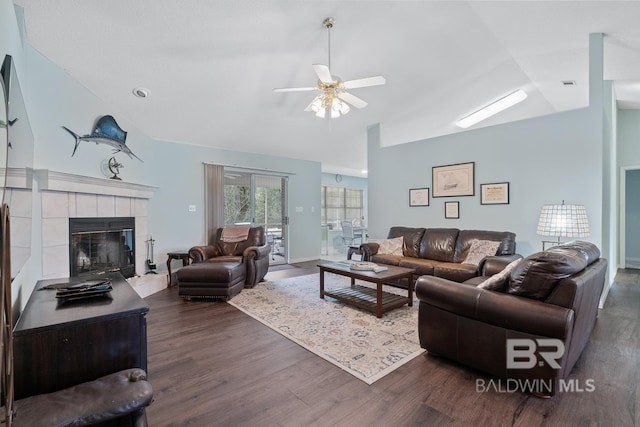 living room with ceiling fan, dark wood-style floors, visible vents, and a tile fireplace