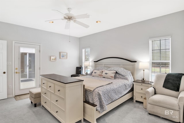 bedroom featuring a ceiling fan and light colored carpet