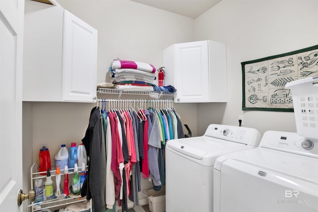 laundry room with washing machine and dryer and cabinet space